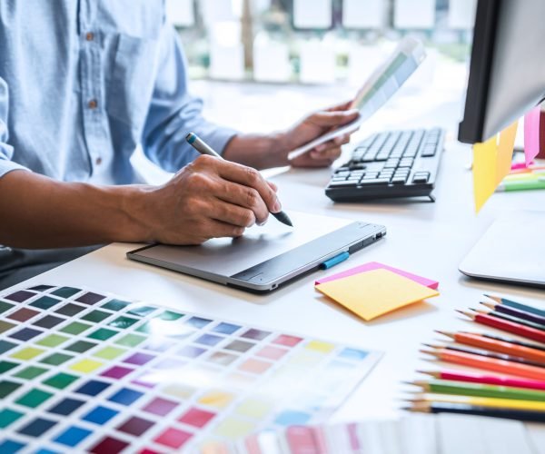 graphic-designer-working-at-desk-with-color-swatch-2026-01-11-08-39-37-utc